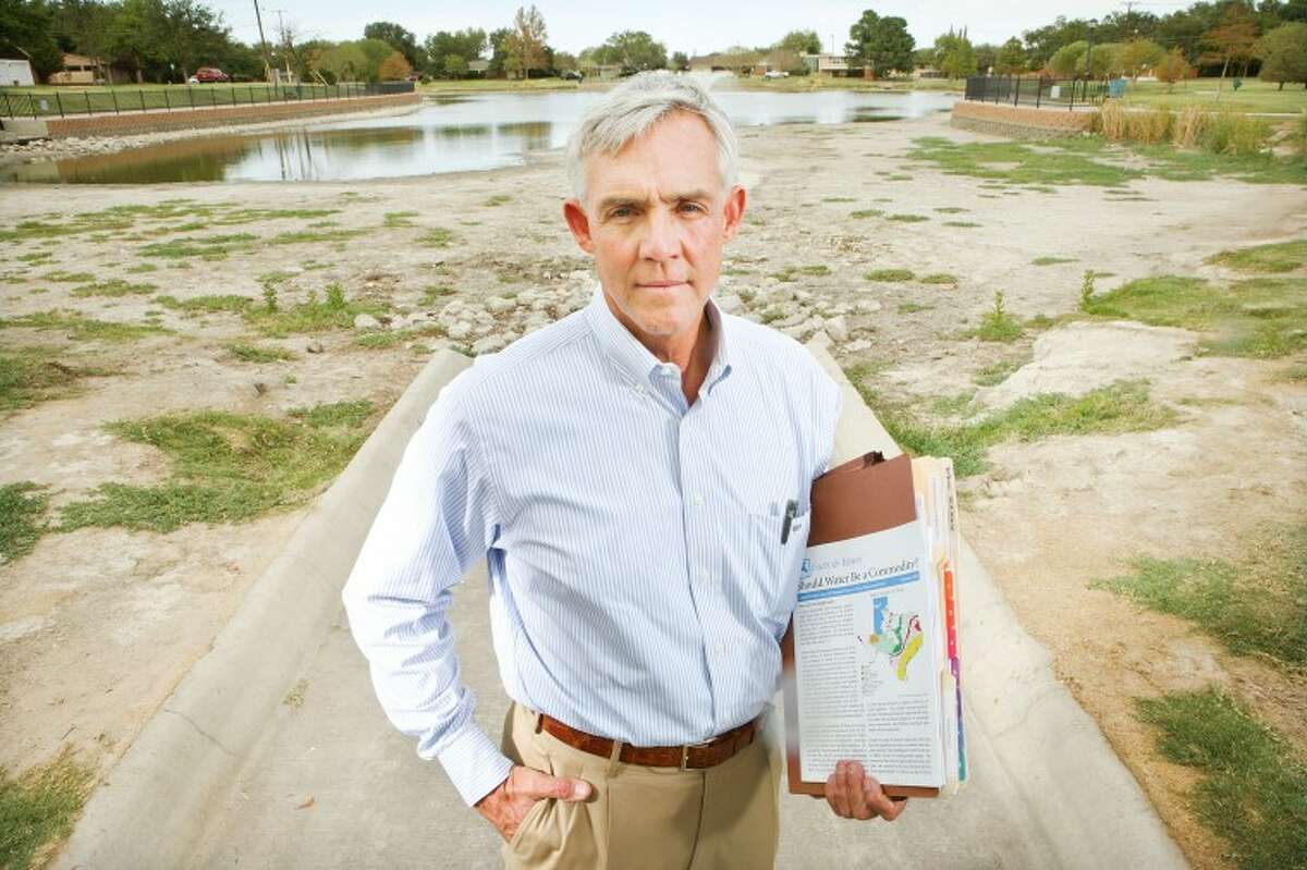 Former Mayor Wes Perry stands in front of a dried-up Wadley Barron pond in this 2011 file photo.
