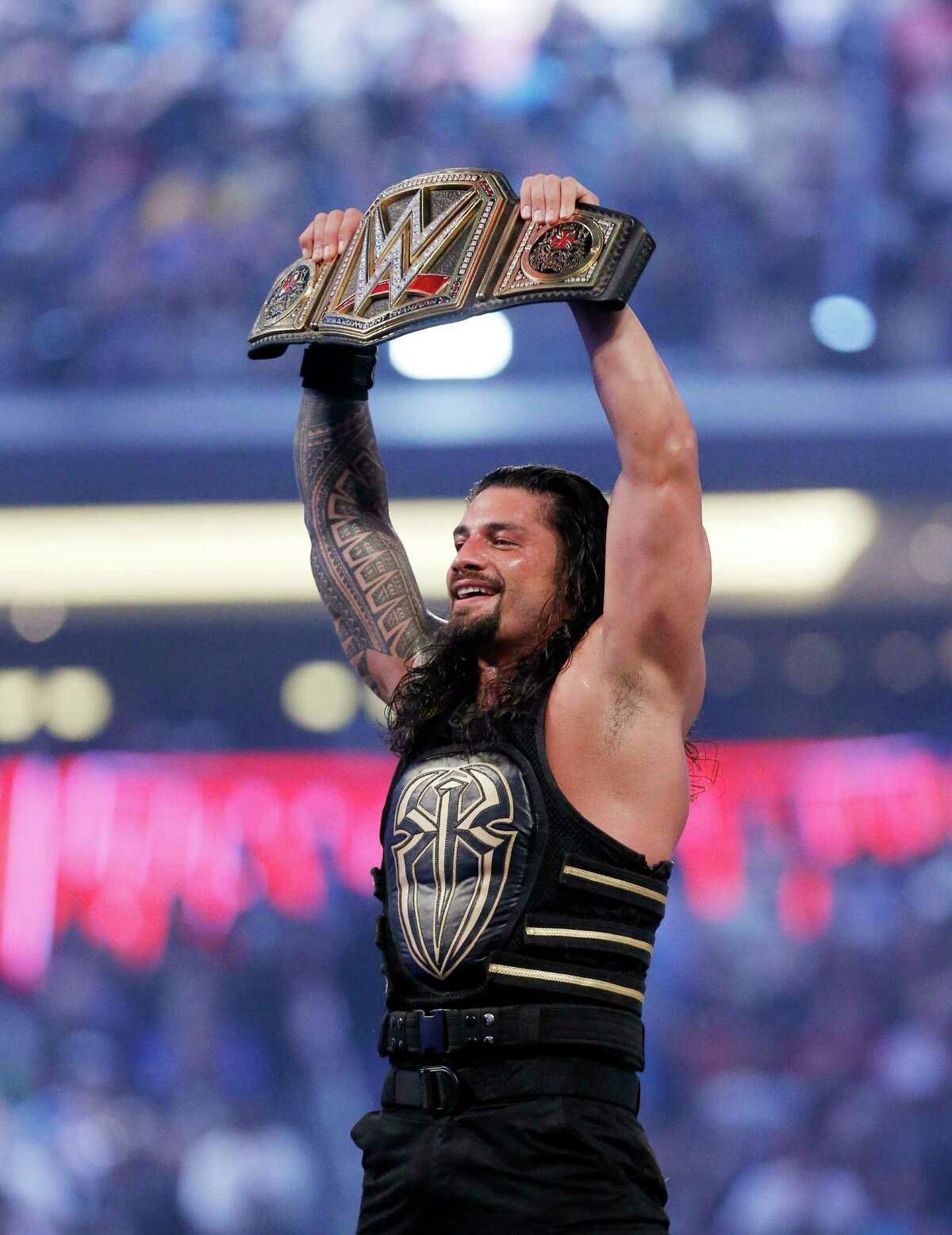 On April 3, 2016, Roman Reigns celebrates his victory at WrestleMania 32 at AT&T Stadium in Arlington, Texas. (Brandon Wade/AP Images for WWE)