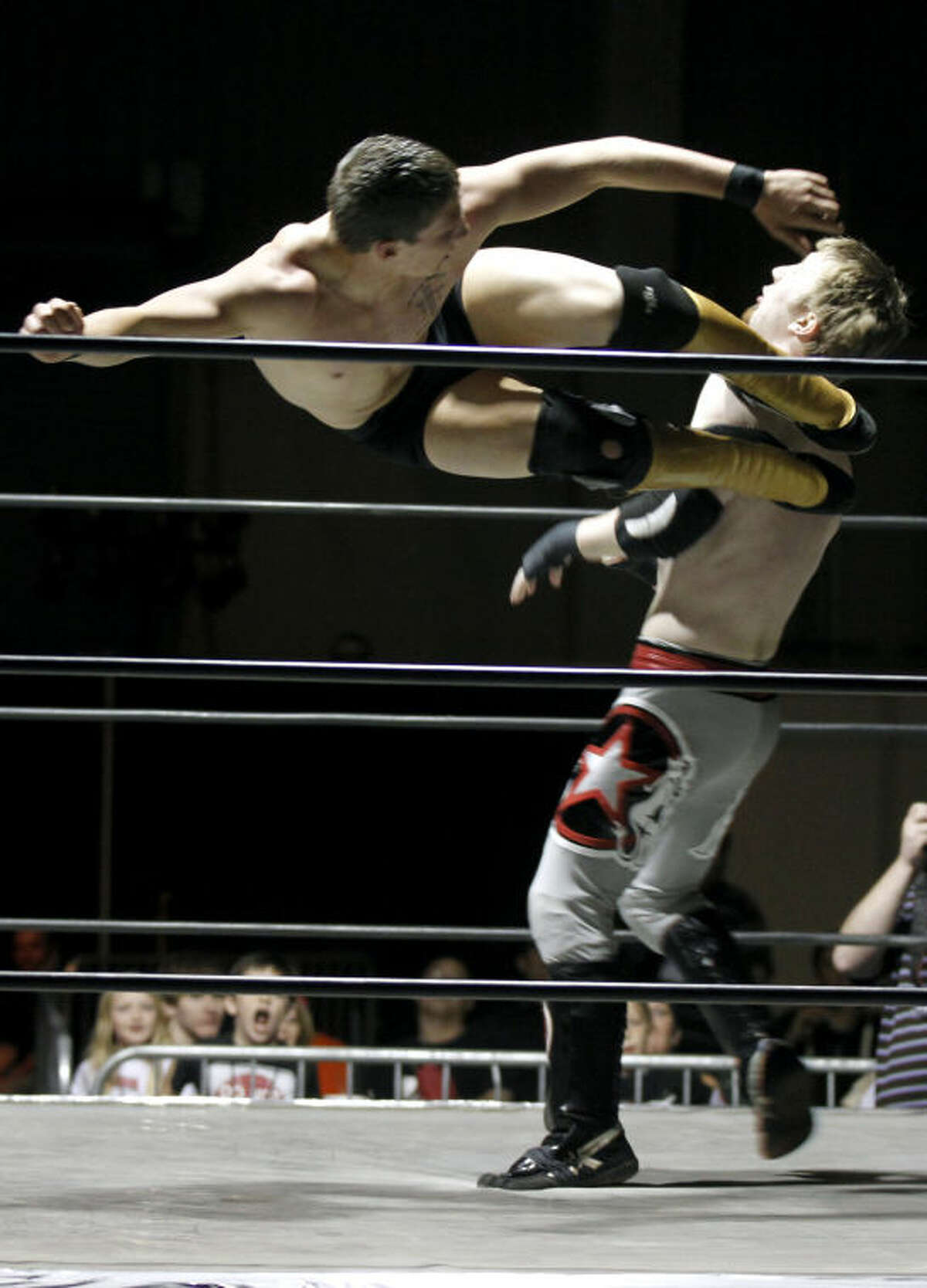 Midlander Aaron Harmes, aka "Cash Commodity," delivers a flying kick to opponent Ryan Justice during the "Breaking The Silence" wrestling event put on by Old School Wrestling of Odessa to raise awareness about bullying and teenage suicide. James Durbin/Reporter-Telegram