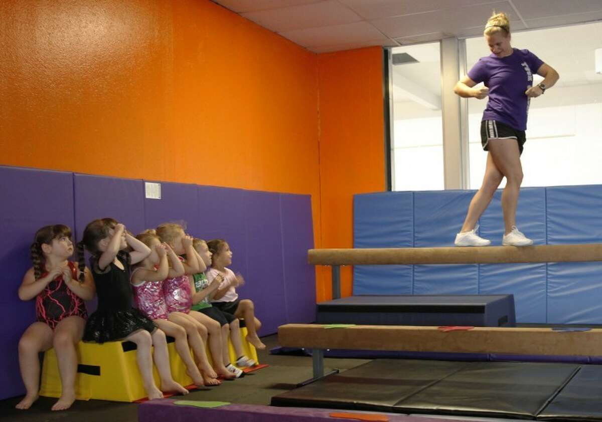 photo of cheerleader looking at her feet - Playground AI