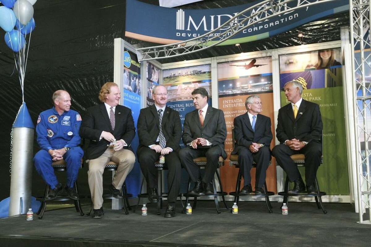 XCOR's Rick Searfoss, director of flight test operations and chief test pilot; from left, Andrew Nelson, chief operating officer; Jeff Greason, president and chief executive officer; Gov. Rick Perry; State Rep.Tom Craddick and Mayor Wes Perry prepare to talk about XCOR Aerospace Inc.’s future in Midland, Monday at Midland International Airport. Cindeka Nealy/Reporter-Telegram