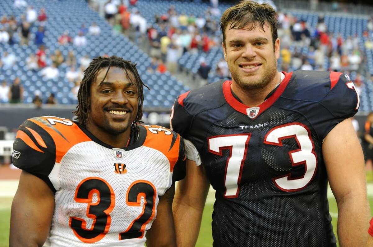 FILE PHOTO -- Former Lee teammates Cedric Benson (32) and Eric Winston (73) share a smile after battling one another at Houston's Reliant Stadium. Winstons" Texans came out on top 35-6, but that didn't seem to matter to old friends.