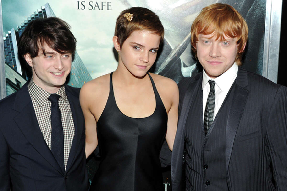 FILE - In this Nov. 15, 2010 file photo, actors, from left, Daniel Radcliffe, Emma Watson and Rupert Grint attend the premiere of "Harry Potter and the Deathly Hallows Part 1" at Alice Tully Hall in New York. Cast as impressionable children in Hollywood's biggest fantasy franchise, Daniel Radcliffe, Emma Watson, Rupert Grint and their many young co-stars have maneuvered through 11 years of fame without any whispers of Lindsay Lohan-style meltdowns that can derail child actors. (AP Photo/Evan Agostini, file)