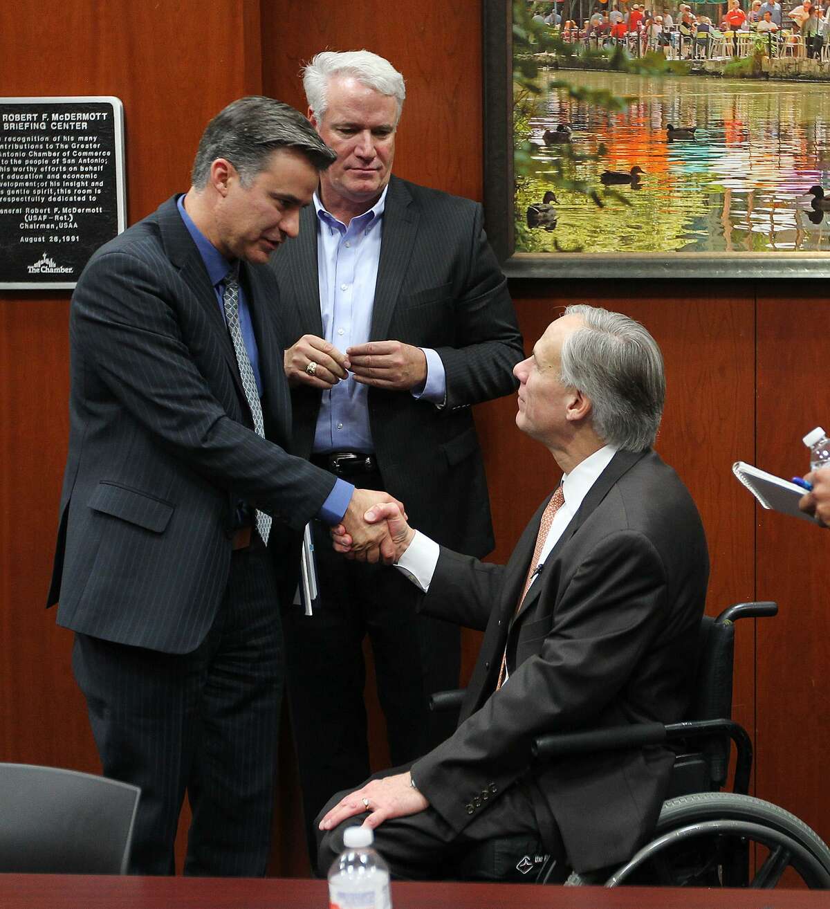 Governor-elect Greg Abbott, right, shakes hands with State Rep. Roland Gutierrez, D-San Antonio, after meeting with area state lawmakers for a legislative roundtable discussion at the San Antonio Chamber of Commerce, Monday, Dec. 15, 2014. Behind them is Rep. Lyle Larson, R-San Antonio. Also at the meeting were San Antonio Democratic representatives Trey Martinez Fischer and Justin Rodriguez.