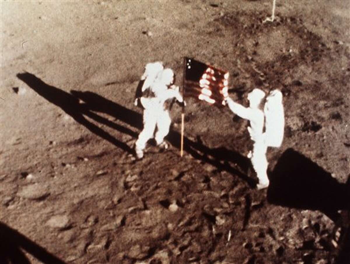 FILE - In this July 20, 1969 file photo provided by NASA shows Apollo 11 astronauts Neil Armstrong and Edwin E. "Buzz" Aldrin, the first men to land on the moon, plant the U.S. flag on the lunar surface. The family of Neil Armstrong, the first man to walk on the moon, says he has died at age 82. A statement from the family says he died following complications resulting from cardiovascular procedures. It doesn't say where he died. Armstrong commanded the Apollo 11 spacecraft that landed on the moon July 20, 1969. He radioed back to Earth the historic news of "one giant leap for mankind." Armstrong and fellow astronaut Edwin "Buzz" Aldrin spent nearly three hours walking on the moon, collecting samples, conducting experiments and taking photographs. In all, 12 Americans walked on the moon from 1969 to 1972. (AP Photo/NASA)