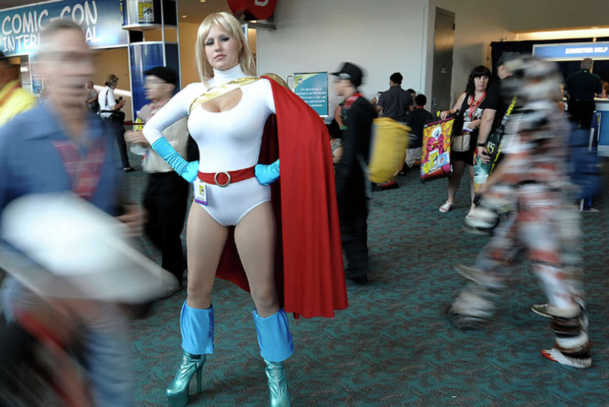 Larson, dressed as Powergirl, poses for photographers at the Comic-Con Inte...