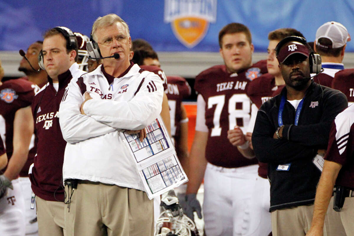 FILE - In this Jan. 7, 2011 file photo, Texas A&M head coach Mike Sherman, left looks on from the sideline during the second half of the Cotton Bowl NCAA college football game against LSU in Arlington, Texas. Texas A&M considered a move to the Southeastern Conference last year before deciding to stay in the Big 12. Now many are wondering if the Aggies' days in the Big 12 are numbered, and what that could mean for the future of the conference. (AP Photo/Tony Gutierrez, File)
