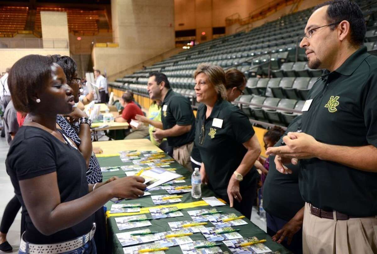 Abigail Kyei, a Junior at Lee High, speaks with Jeremy Martinez, Director of Admissions for Midland College, during the College Forum Thursday at the Chaparrel Center. The free event gave students and families the opportunity to meet representatives from various area colleges. James Durbin/Reporter-Telegram