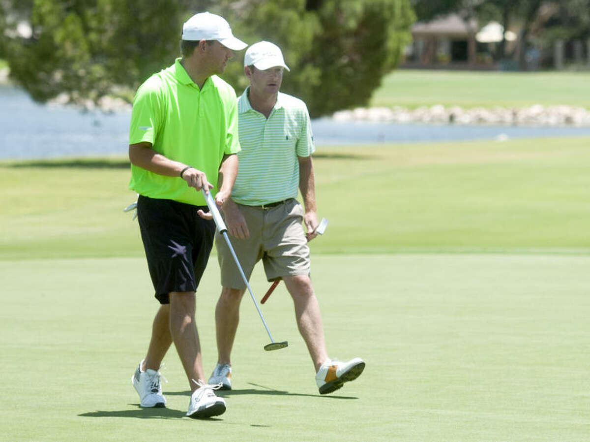 Brady Shivers (left) and Terence Begnel (right) walk off the green after putting during day 2 of the Green Tree Jamboree Saturday at Green Tree Country Club. James Durbin/Reporter-Telegram