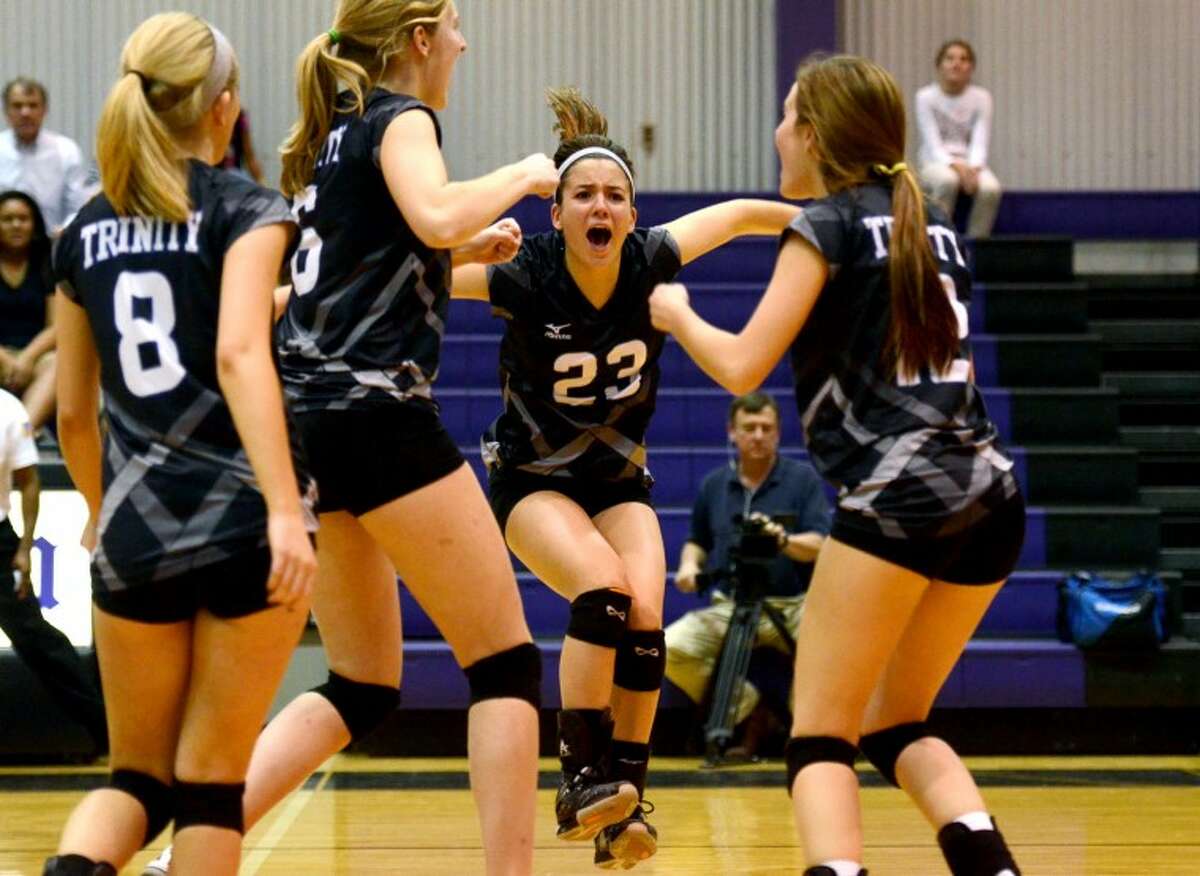 In this October 2012 file photo, the Trinity School volleyball team celebrates after scoring against Midland Classical Academy. James Durbin/Reporter-Telegram
