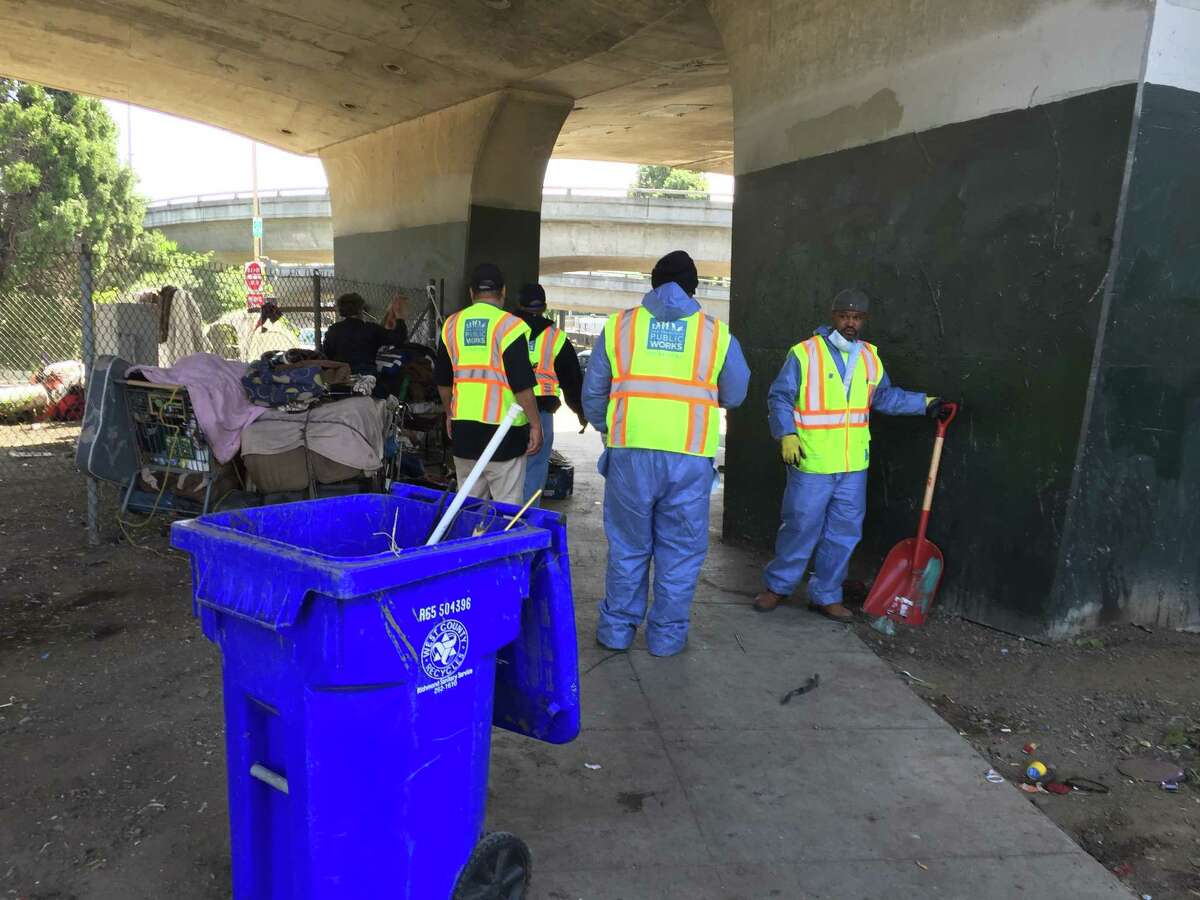 City cleanup crews, counselors and police clear out a large camp of homeless people on Cesar Chavez Street around Highway 101.