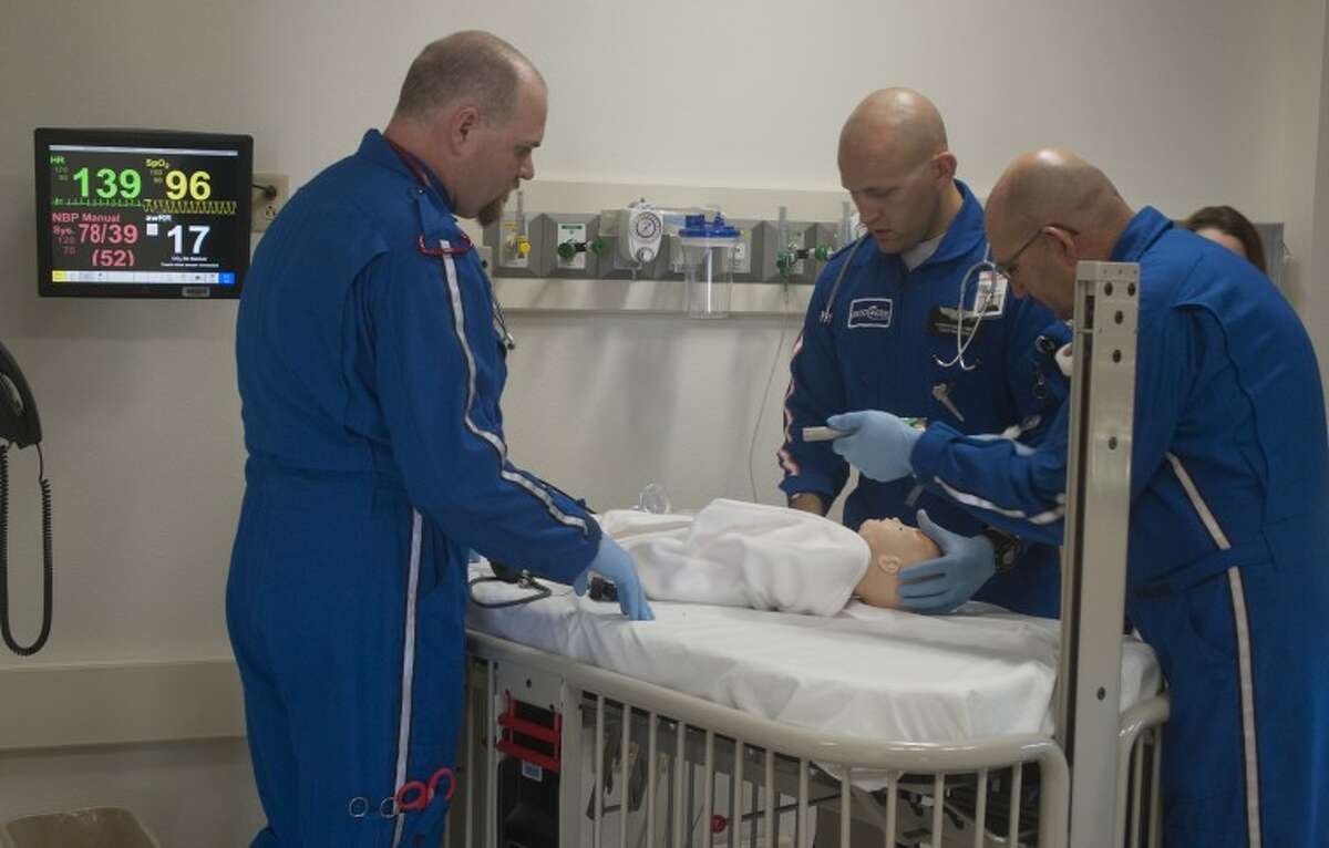 Rick Morre, RN, BSA and flight nurse, Kenneth Hawley, EMT, flight paramedic and Joe Harper, right, EMT, flight paramedic, train Tuesday at Midland College SimLife Center on a simulated two-year-old burn victim they had to pick up in helicopter with AreoCare. Tim Fischer\Reporter-Telegram