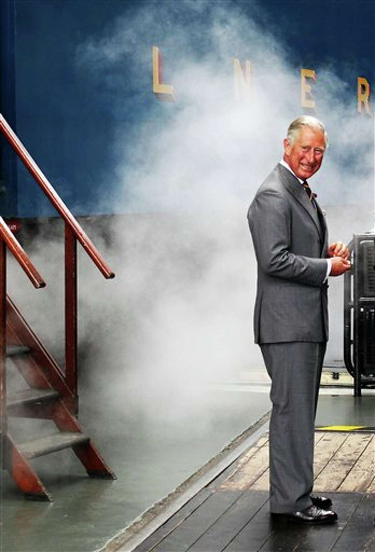 Britain's Prince Charles arrives on the Bittern steam locomotive as he visits the National Railway Museum in York, Britain, Monday, July 22, 2013. Prince William's wife, Kate, is in the early stages of labor in a private wing of a central London hospital, palace officials said Monday. It is a historic moment for the British monarchy — the couple's first child will become third in line for the British throne, after Prince Charles and William, and should eventually become king or queen. (AP Photo/PA, Lynne Cameron) UNITED KINGDOM OUT, NO SALES, NO ARCHIVE