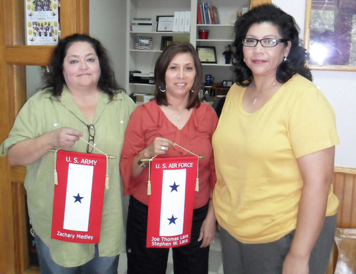 Blue Star moms Michelle Medley, Sylvia Lara and Melissa Ybarra pose with their banners honoring their sons who are serving in the military. The ladies are part of the Ozona Military Support Group that meets and helps lend a hand to those whose children are active in the military.