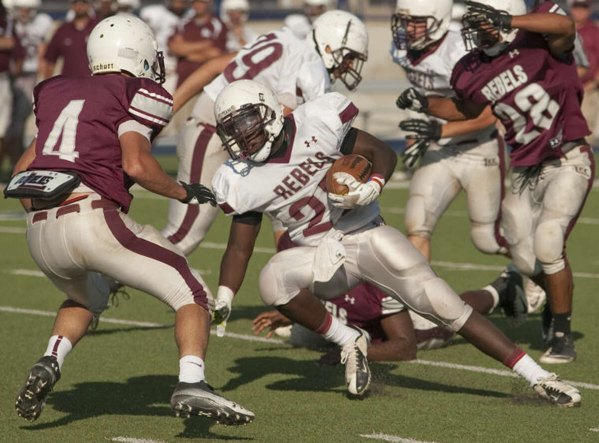 Lee White squad's Aron Dobbins tries to cut back as Lee Maroon squad's Abel Sanchez looks to stop him Friday in the annual Maroon and White Lee football game. Tim Fischer\Reporter-Telegram
