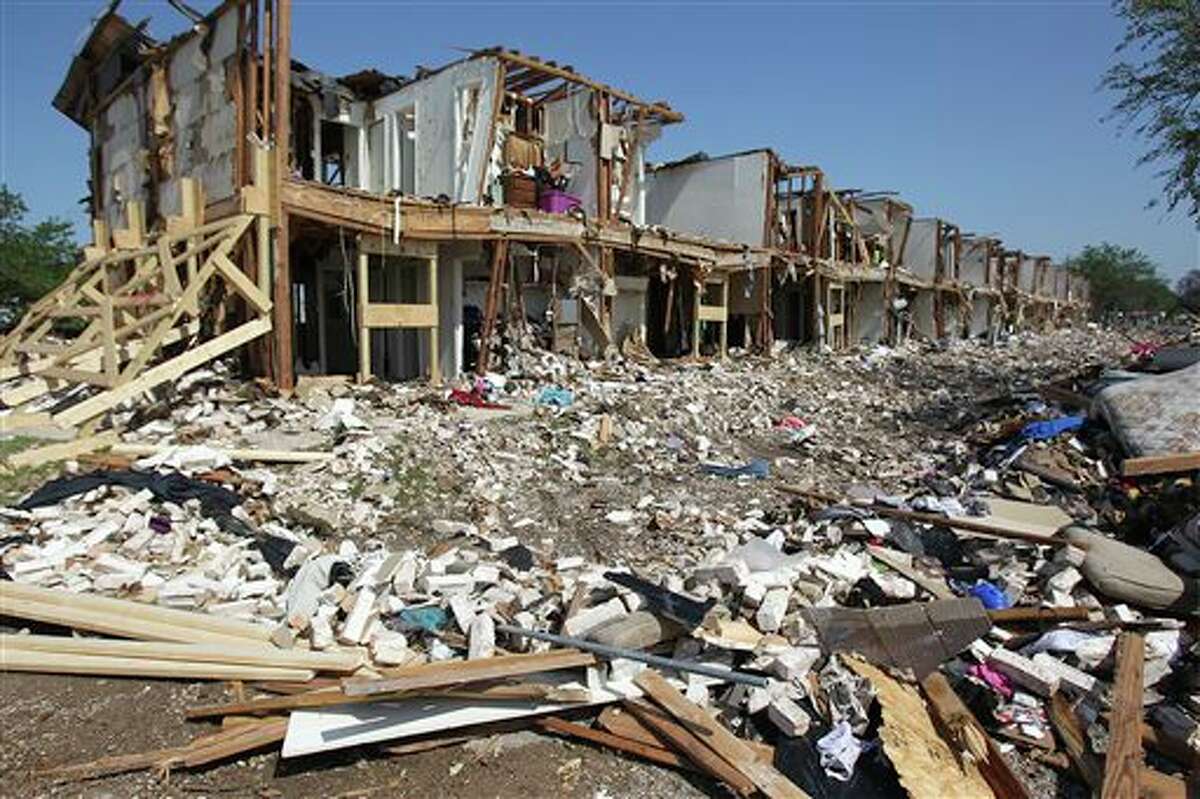 Debris litters the ground outside a destroyed apartment complex adjacent to the site of the fire and explosion in West, Texas on Wednesday, April 24, 2013. The explosion at West Fertilizer which killed 14 people left a crater more than 90 feet (27 meters) wide and blasted the walls and windows off dozens of buildings in the town of 2,700. (AP Photo/The San Antonio Express-News, Tom Reel, Pool)