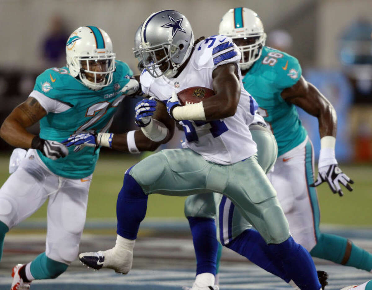 Dallas Cowboys running back Phillip Tanner (34) runs the ball for a 9-yard gain in the second quarter against the Miami Dolphins during the Pro Football Hall of Fame game Sunday in Canton, Ohio. (AP Photo/Scott R. Galvin)