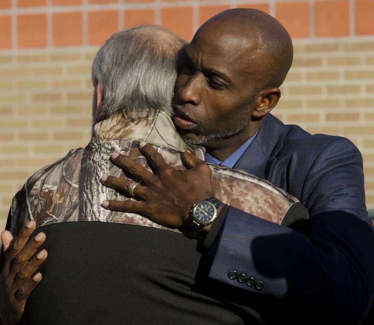 Pastor Roy Smith comforts Terry Johnson Friday morning following a community prayer service for all those involved in the veterans parade accident. Tim Fischer\Reporter-Telegram