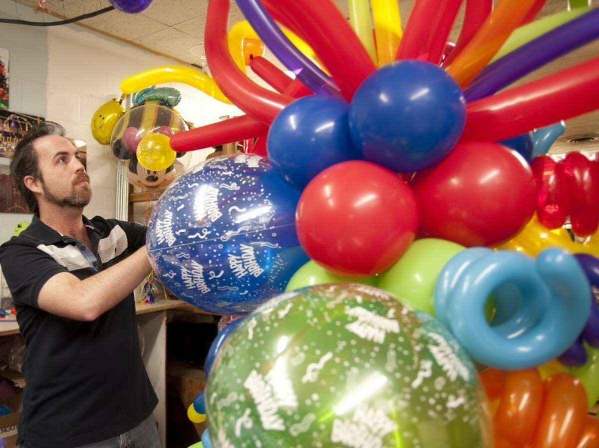 Cody Williams makes balloon masterpieces at Mark Knox Flowers in Odessa. Tim Fischer\Reporter-Telegram
