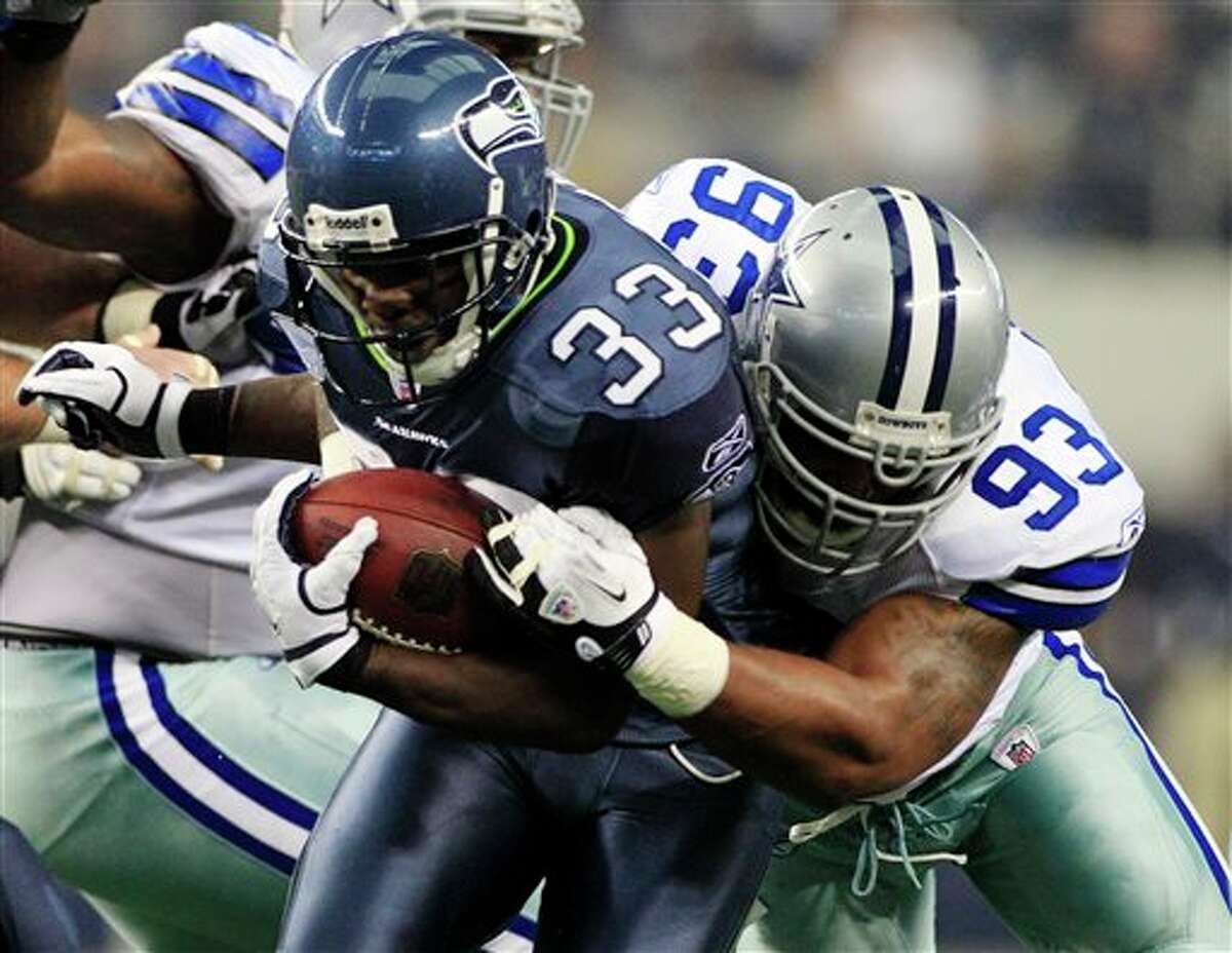 Seattle Seahawks' Leon Washington (33) is taken down by Dallas Cowboys' Anthony Spencer during the first half of an NFL football game on Sunday, Nov. 6, 2011, in Arlington, Texas. (AP Photo/Tony Gutierrez)