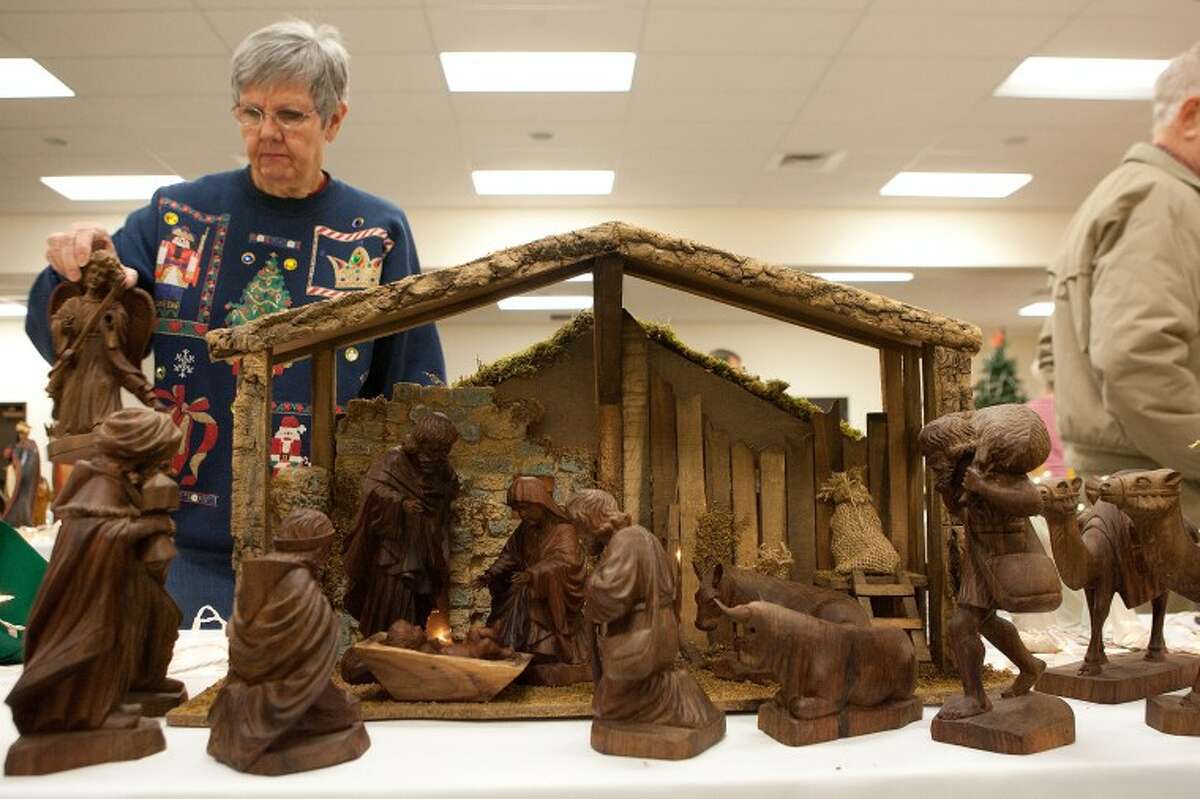 Edie White adds the final piece to her hand-carved Ecuadorian Nativity scene Friday during preparation for the 2010 "No Room at the Inn" exhibit at Grace Presbyterian Church. Cindeka Nealy/Reporter-Telegram