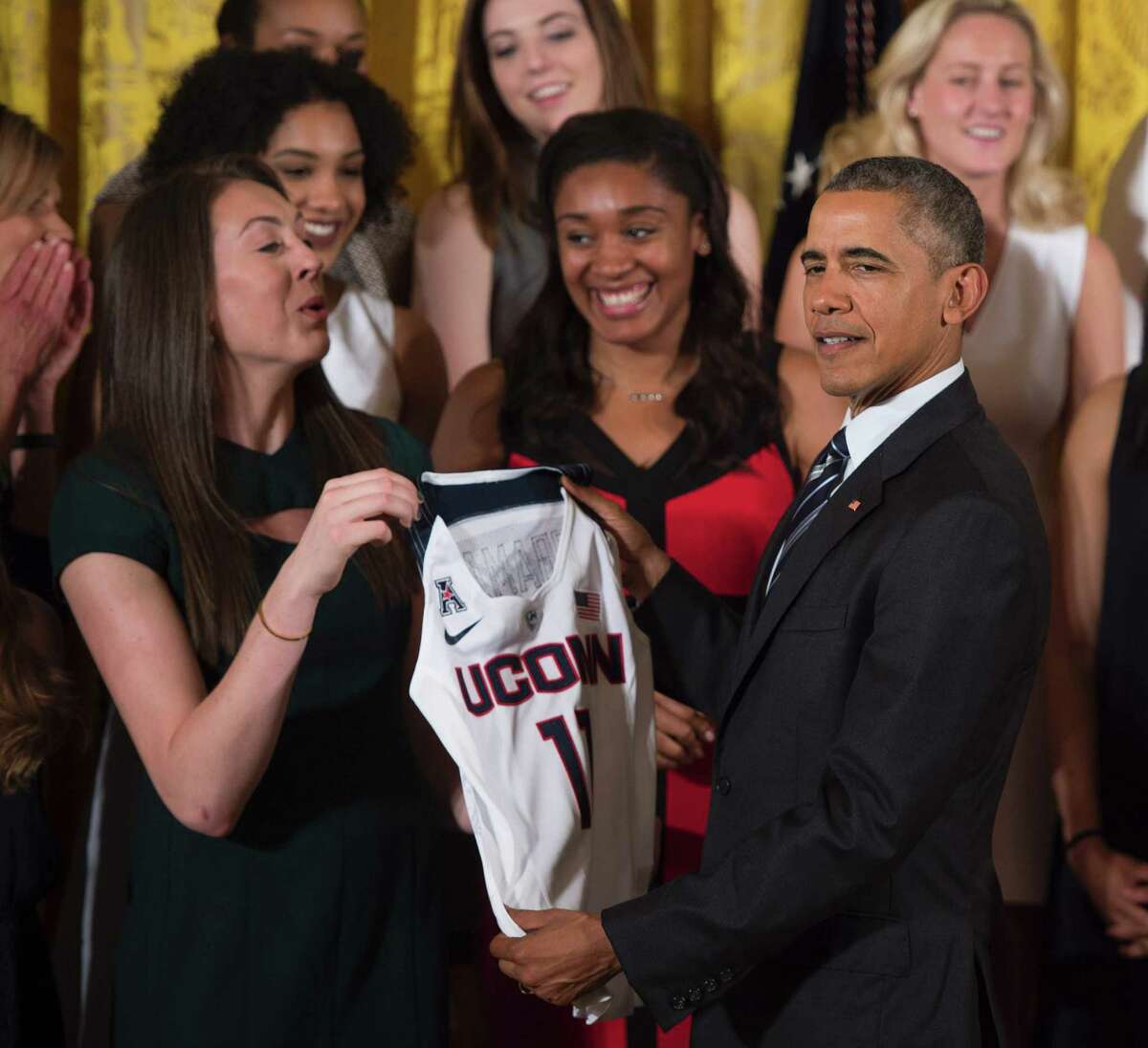US President Barack Obama holds a women's jersey as he poses with player Breanna Stewart at the White House in Washington, DC, May 10, 2016, during an event welcoming the 2016 NCAA Champion UConn Huskies women's basketball team.