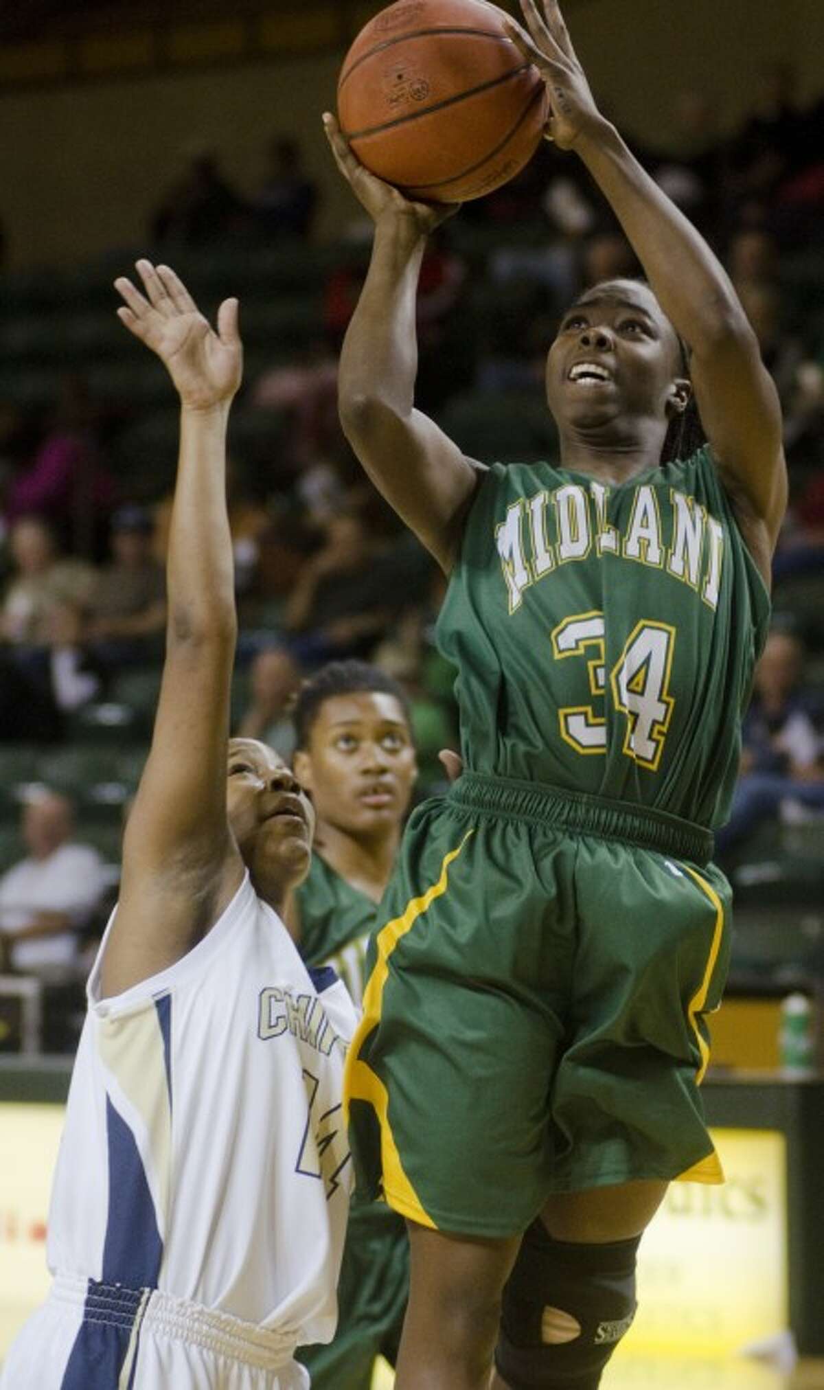 Midland College's Danesha Long puts up a shot over Chipola College's Denaya Brazzle Friday night in the semifinal game of the Women's National Invitational Tournament. Photo by Tim Fischer/Midland Reporter-Telegram
