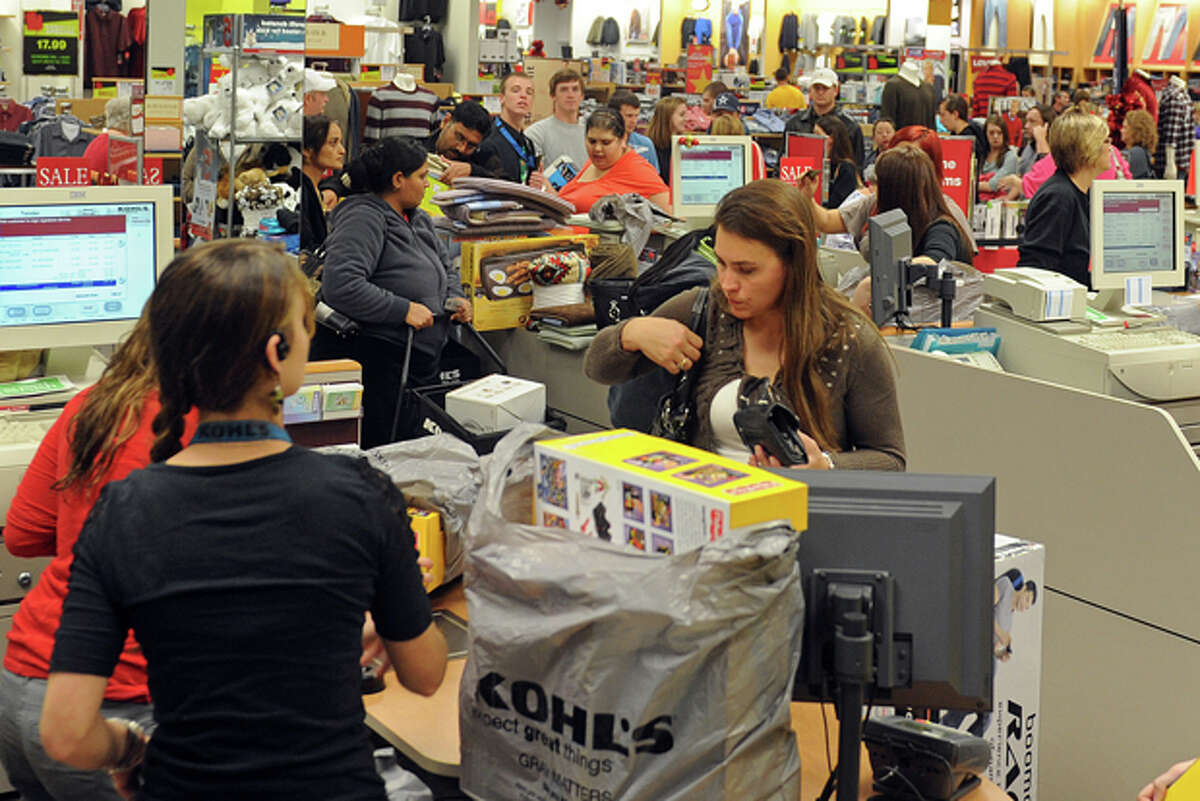 Customers check out at Kohl's in Wichita Falls, Texas as lines wrapped around the store on both sides and back down the center aisles by 1:30 a.m. Kohl's opened at midnight for Black Friday, along with other retail stores such as Best Buy. (AP Photo/Wichita Falls Times Record News, Patrick Johnston)