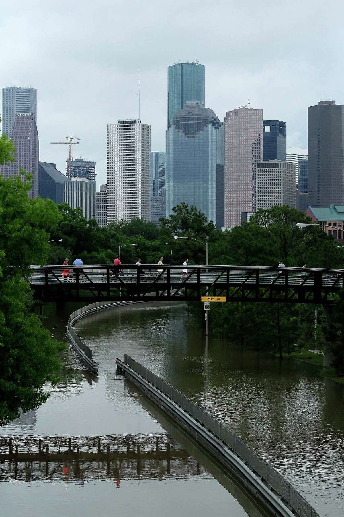 Onlookers at Buffalo Bayou checking out flooding on Monday, April 18, 2016, in Houston. ( Elizabeth Conley / Houston Chronicle )