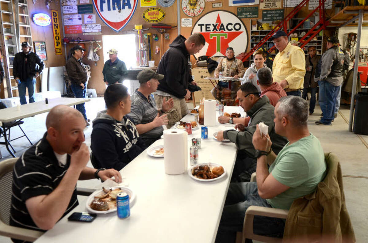 Members of the Patriot Guard participate in a barbecue after welcoming wounded veterans at Midland International Airport Thursday as part of the "Reel Thanx" fishing trip program for wounded servicemen. James Durbin/Reporter-Telegram