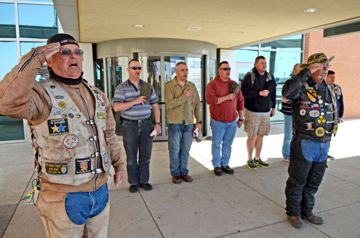 Patriot Guard ride captain "Wild Bill" McNeill leads the Pledge of Allegiance after members of the Patriot Guard welcomed soldiers arriving at Midland International Airport Thursday as part of the "Reel Thanx" fishing trip program for wounded servicemen. James Durbin/Reporter-Telegram