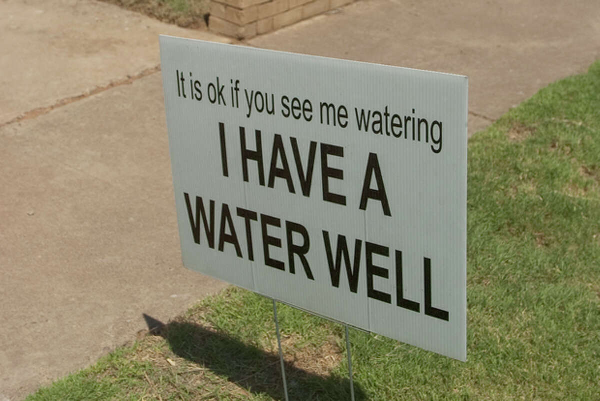 Some residents have placed signs in their yard to inform others they use a water well to help water htre yard. Photo by Tim Fischer/Midland Reporter-Telegram