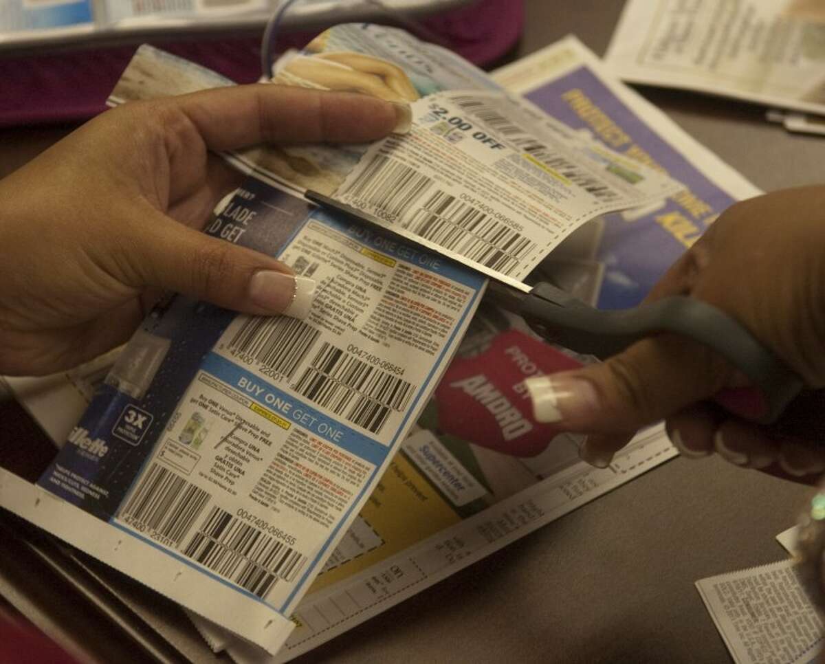 Celestine Lunda buys four Sunday papers to get the extra coupons in the inserts, after cutting them out she places them in her coupon holder book to keep everything organized. Photo by Tim Fischer/Midland Reporter-Telegram