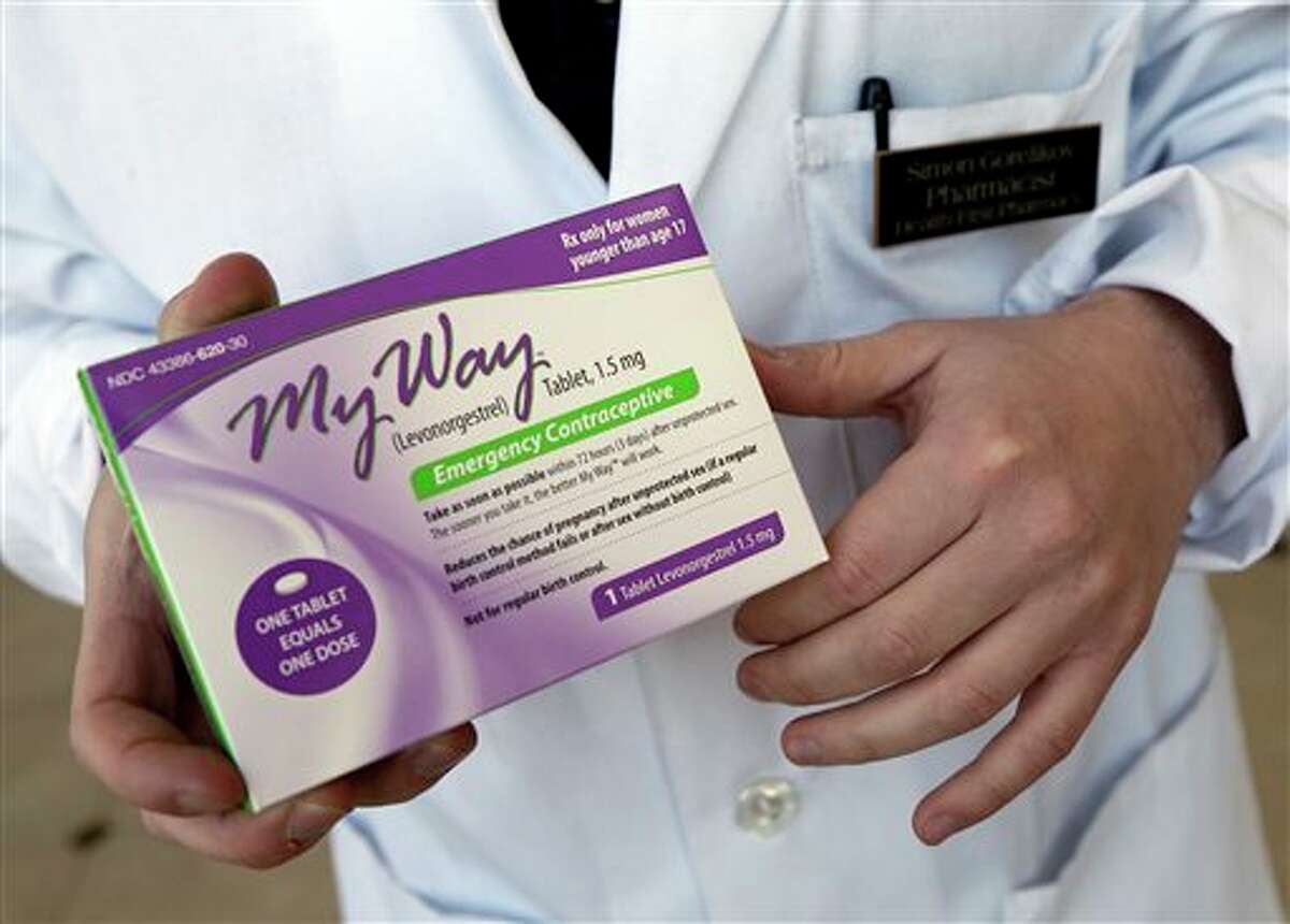 FILE - In this May 2, 2013 photo, pharmacist Simon Gorelikov holds a generic emergency contraceptive, also called the morning-after pill, at the Health First Pharmacy in Boston. The Obama administration on Monday, May 13, 2013 filed a last-minute appeal to delay the sale of the morning-after contraceptive pill to girls of any age without a prescription. (AP Photo/Elise Amendola, File)