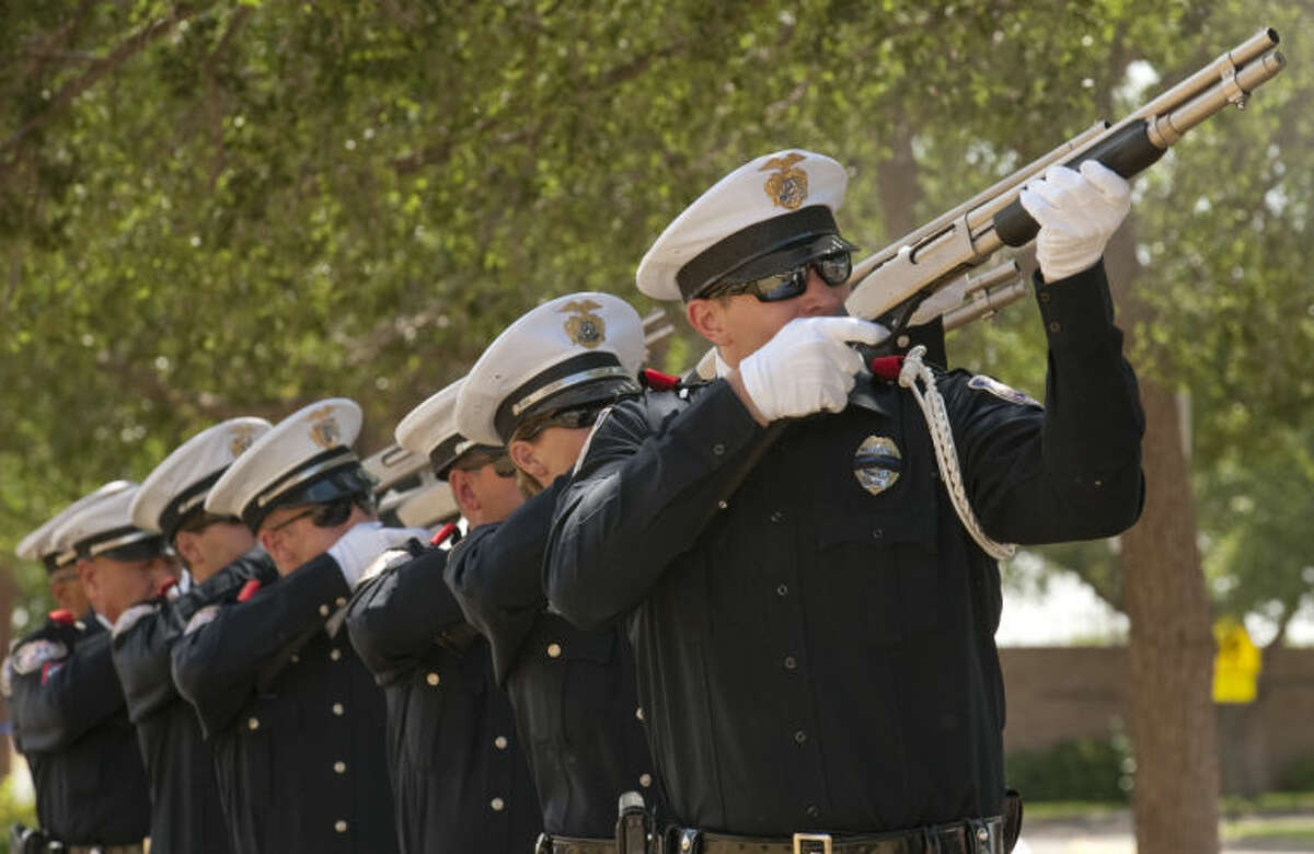 Members of Midland Police Honor Guard fire a 21 gun volley salute Wednesday during the memorial for Texas officers who lost their lives last year. Tim Fischer\Reporter-Telegram