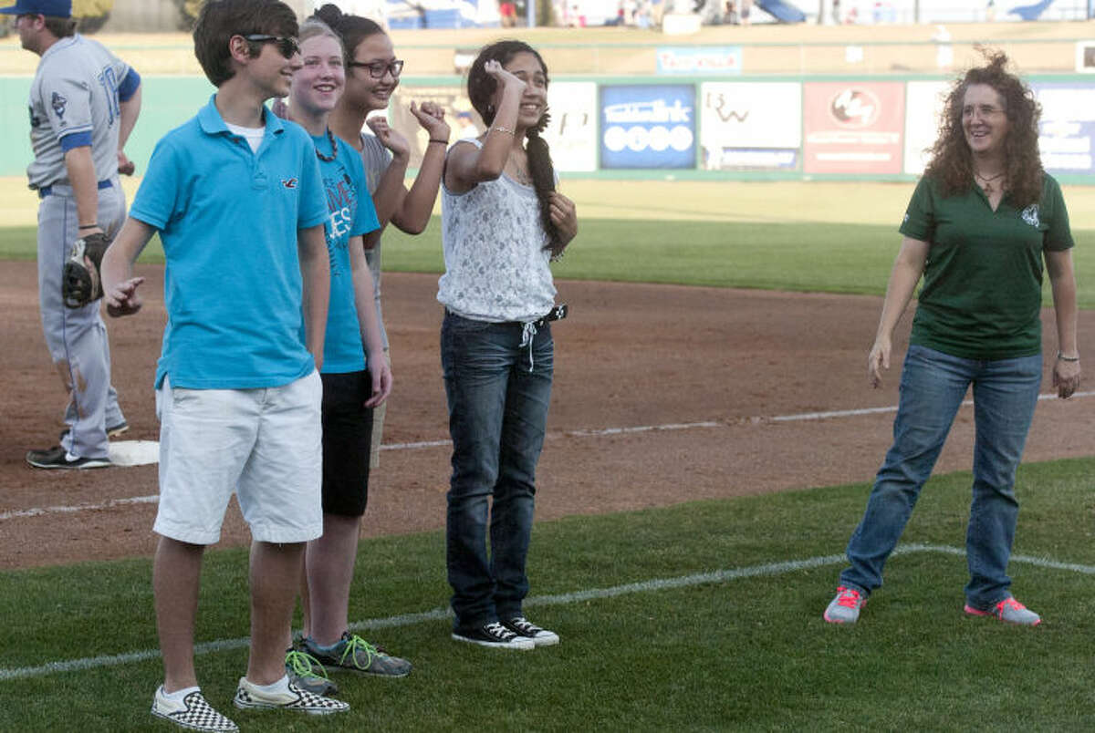 San Jacinto Junior High students from left, Bernardo Rincon, Megan Tyre, Anh Vo, Daisy Gonzalez and school principal Deborah Kendrick, far right, were recognized for their perfect attendance and straight-A grades during the RockHounds game Wednesday, May 29 against the Tulsa Drillers at Citibank Ballpark. James Durbin/Reporter-Telegram