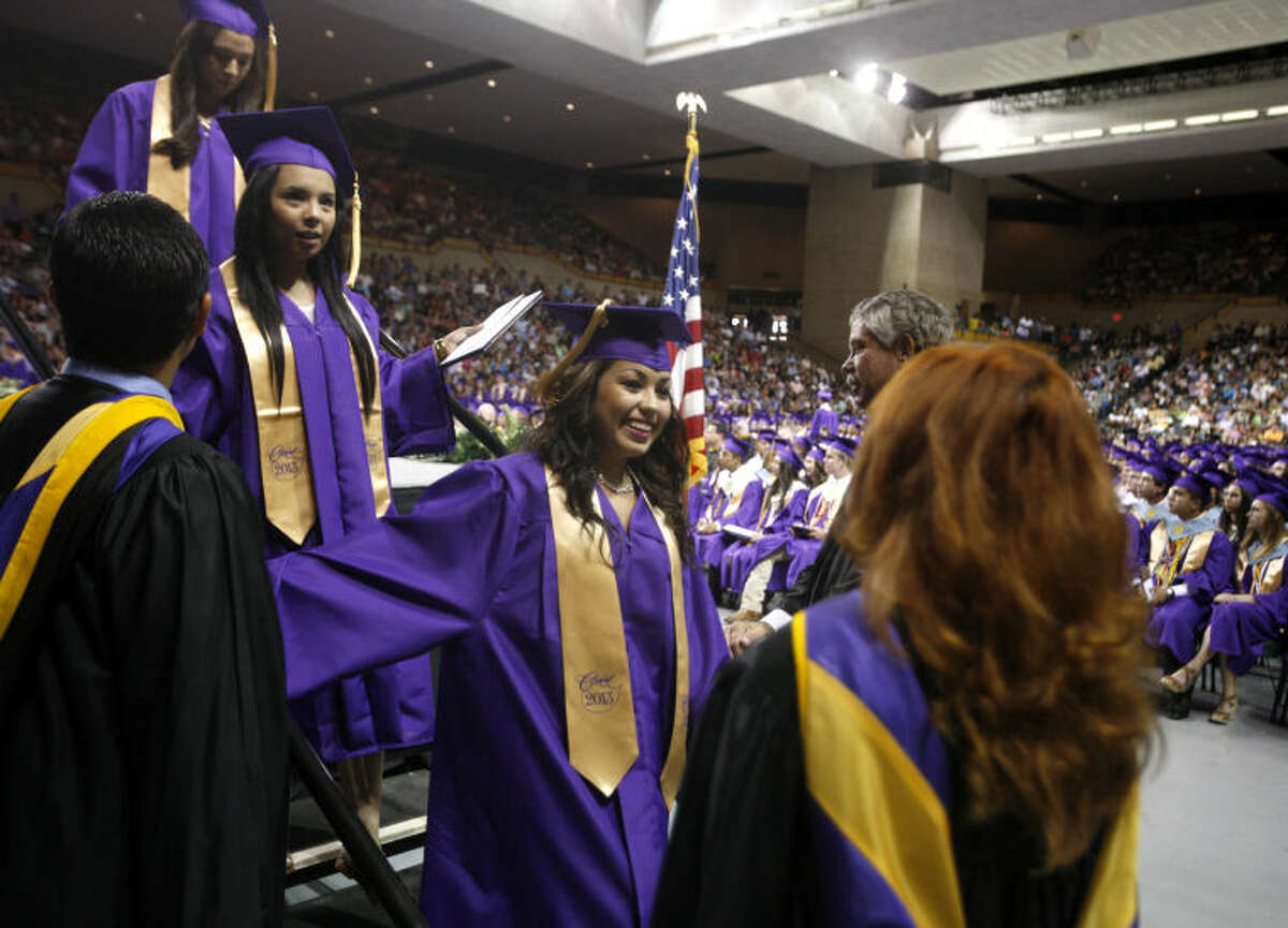 Midland High graduates walk across the stage during the graduation ceremony Saturday at Chaparral Center. James Durbin/Reporter-Telegram