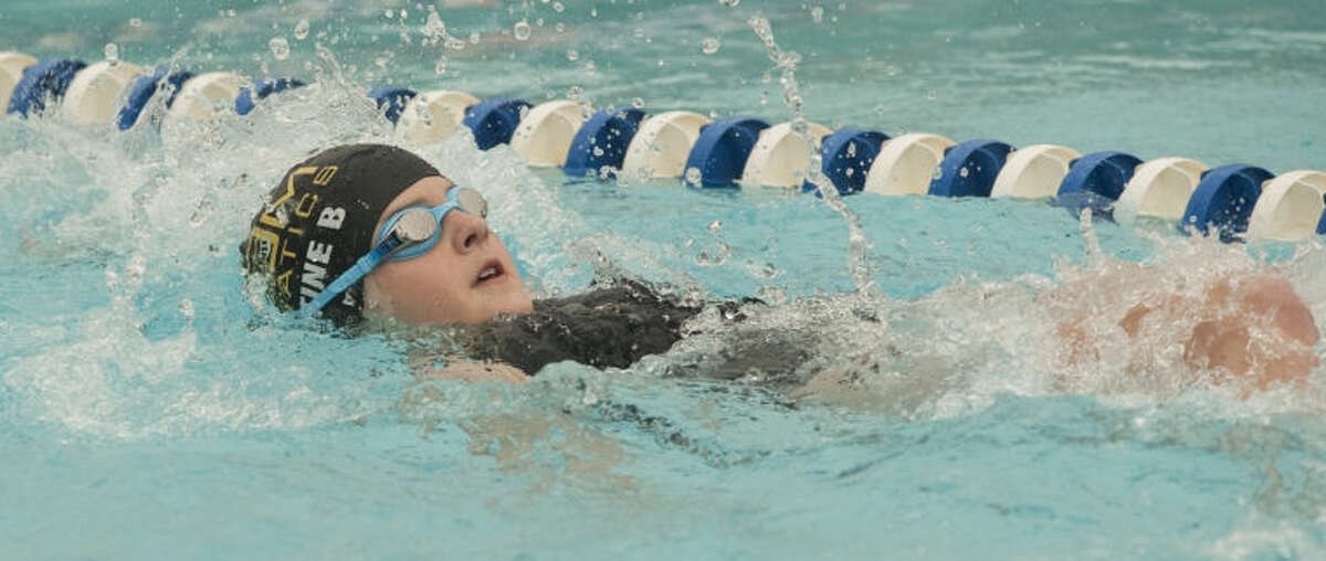 COM's Justine Bahm swims Friday in the girls 12 and under 100 m backstroke at the Western National Bank Invitational at Doug Russell Pool. Tim Fischer\Reporter-Telegram