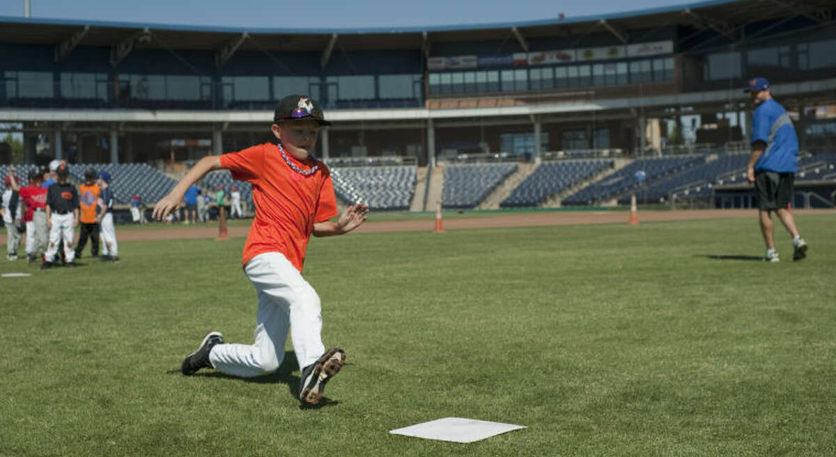 Toby Delk makes a slide into second as he and others participate in the RockHounds Kids Camp at CitiBank Ballpark. Tim Fischer\Reporter-Telegram