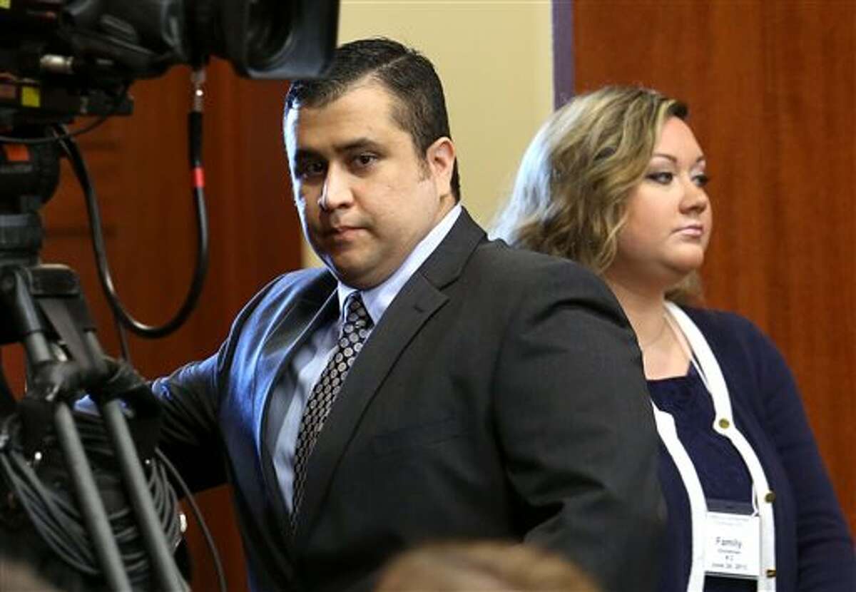 FILE - In this Monday, June 24, 2013 file photo, George Zimmerman, left, arrives in Seminole circuit court with his wife, Shellie, on the 11th day of his trial, in Sanford, Fla. George Zimmerman's wife filed for divorce Thursday, Sept. 5, 2013 less than two months after her husband was acquitted of murdering Trayvon Martin and a week after she pleaded guilty to perjury in his case. (AP Photo/Orlando Sentinel, Joe Burbank, Pool, File)