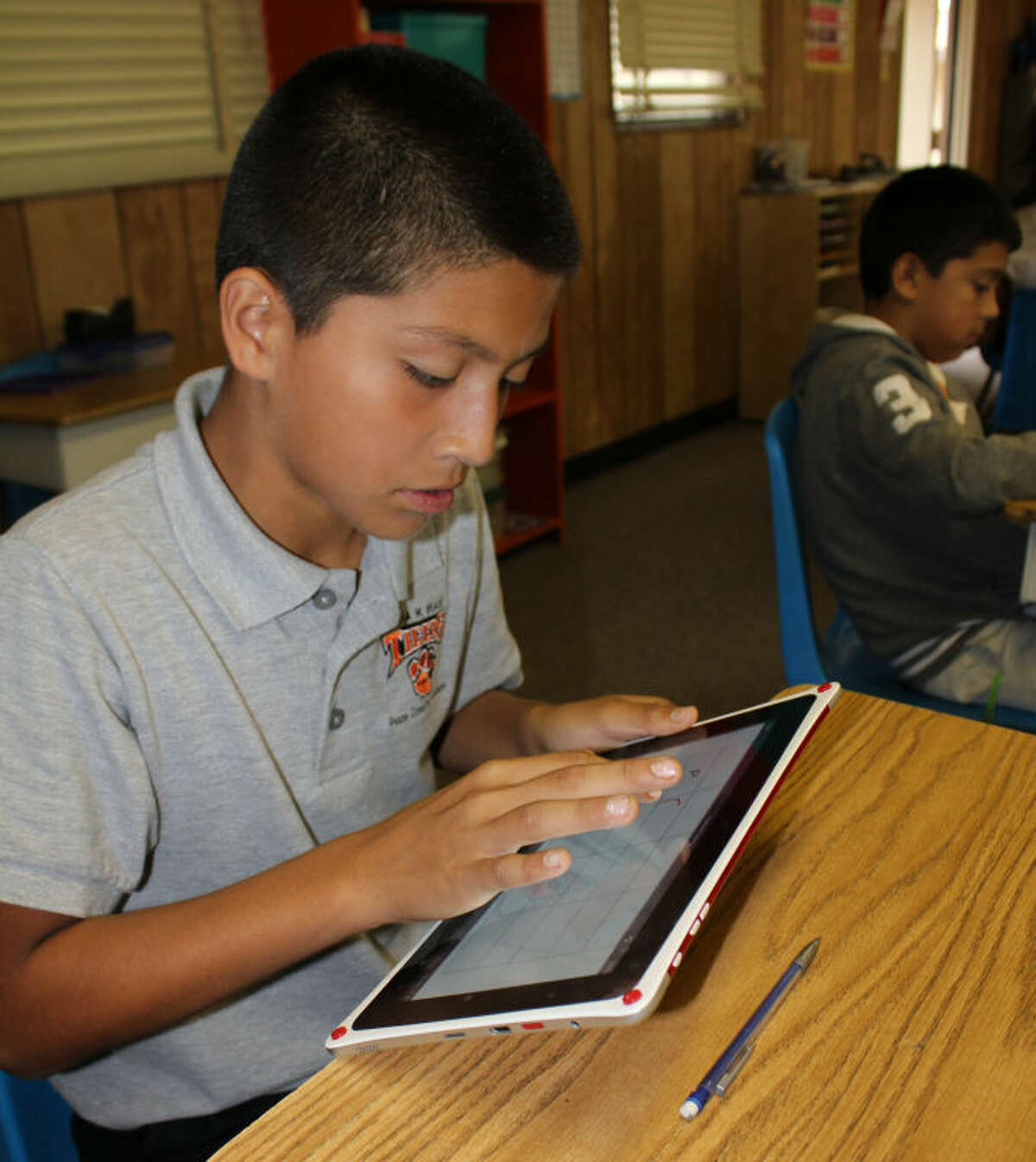 Thomas Davila, 11, uses his LearnPad to complete a worksheet about order of operations Tuesday morning at Pease Communication and Technology Academy. Meredith Moriak/Reporter-Telegram