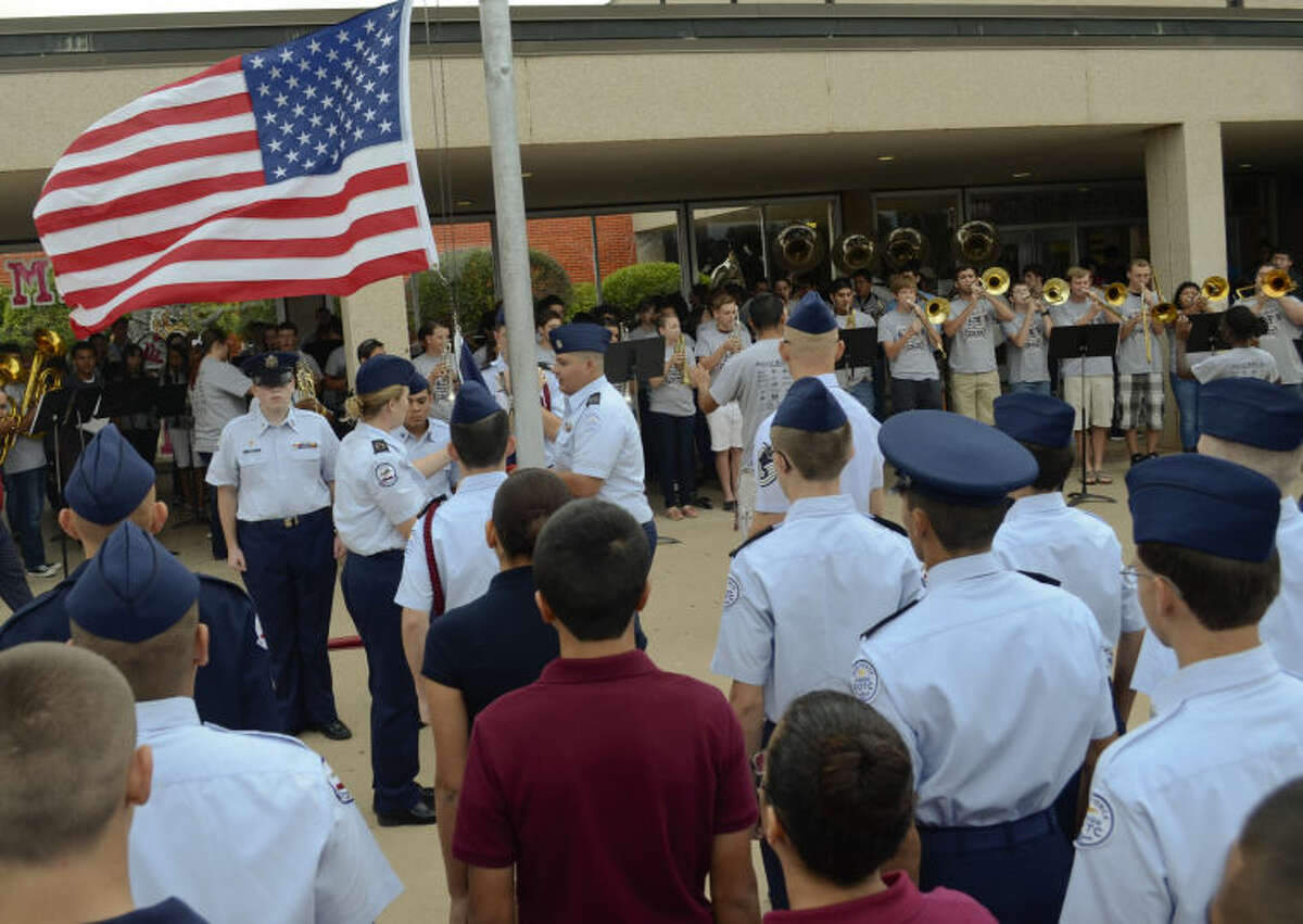 Lee High School JrROTC, band members, students and teachers gather at the flag pole Wednesday outside the school for a special flag ceremony in remembrance of September 11. Tim Fischer\Reporter-Telegram