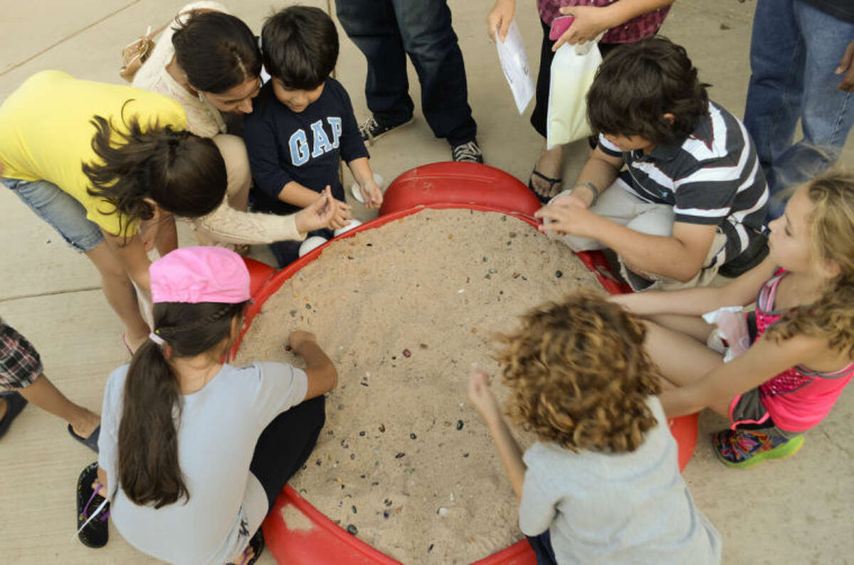 Children search for gems in a sandbox Thursday evening during Family Science Night at the Petroleum Museum. Tim Fischer\Reporter-Telegram