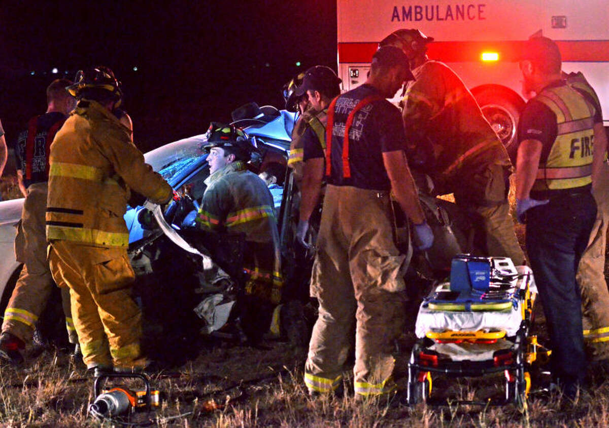 Midland emergency personnel work to extract a man from his vehicle after a two-vehicle collision Tuesday night on Hwy 191. James Durbin/Reporter-Telegram