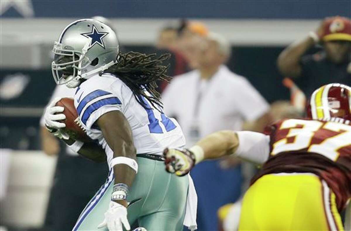 Dallas Cowboys wide receiver Dwayne Harris (17) escapes a tackle attempt by Washington Redskins' Reed Doughty (37) on a punt return in the second half of an NFL football game, Sunday, Oct. 13, 2013, in Arlington, Texas. (AP Photo/Tim Sharp)