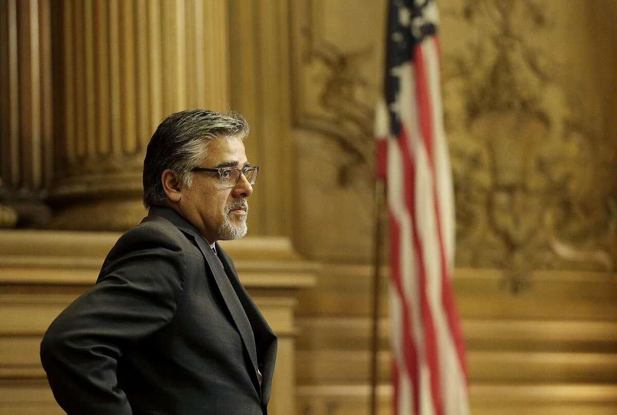 Supervisor John Avalos stands during a Board of Supervisors meeting at City Hall in San Francisco, Tuesday, May 10, 2016. The Board of Supervisors plans to vote on May 24 on whether to reaffirm its strict protections and spell out when immigrants can be turned over to the U.S. government, nearly a year after a shooting death along a San Francisco pier sparked a national debate on how the city handles immigrants in the U.S. illegally. (AP Photo/Jeff Chiu)
