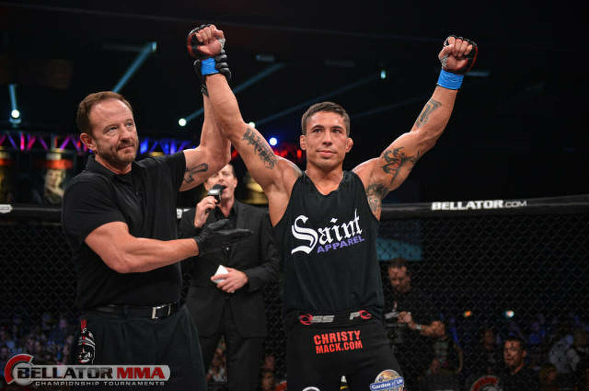 Kerry Hatley, left, raises the arm of a Mixed Martial Arts fighter during a Bellator fight card recently. Hatley lives in Midland and has been refereeing at major MMA bouts for more than a decade.Photo courtesy of Bellator MMA