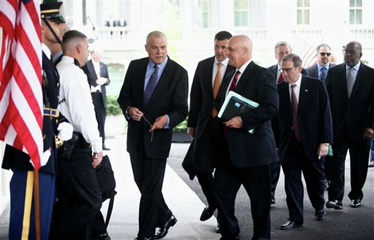 From left, Aetna CEO Mark Bertolini, Humana CEO Bruce Broussard, Blue Cross Blue Shield of Florida CEO Patrick Geraghty, and other health care chief executive officers arrive at the White House in Washington, Wednesday, Oct. 23, 2013, to meet with White House officials regarding President Barack Obama's health care law. (AP Photo/Charles Dharapak)