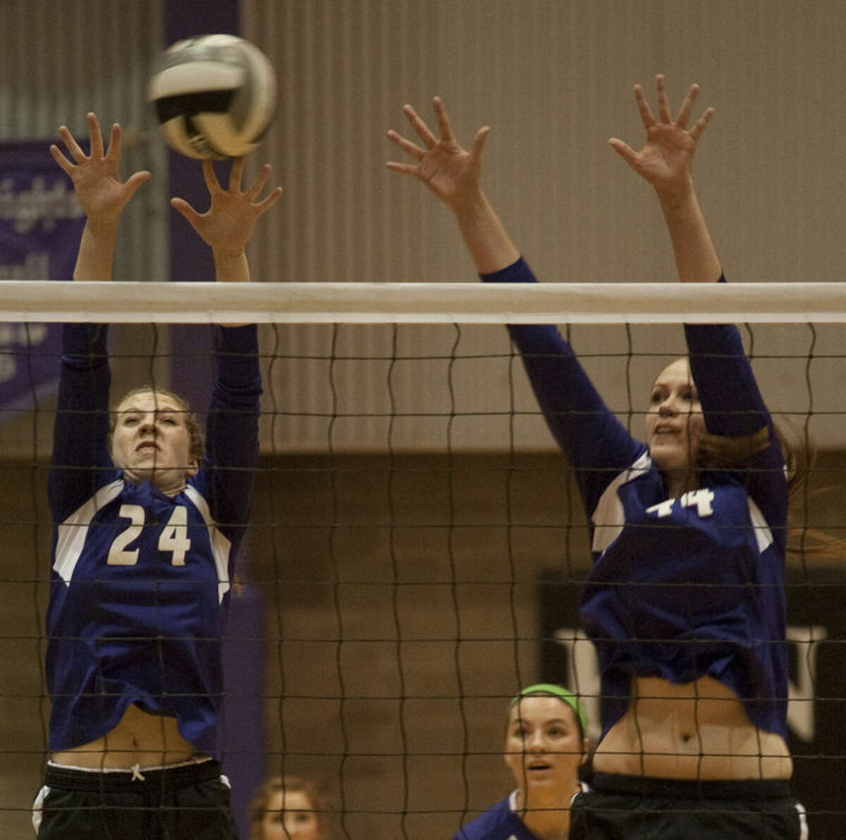 Midland Classical Academy's Alissa Beattie, 24 and Danilelle Jackson, 44, go up for a block Tuesday during a playoff match against Fort Worth Bethesda. Tim Fischer\Reporter-Telegram