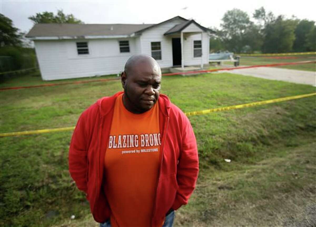 FILE - In this Tuesday, Oct. 29, 2013 file photo, Terrence Walker of Forney, Texas, the brother of 36-year-old Charles Everett Brownlow Jr., stands in front of the house of their mother, Mary Brownlow, as he answers a reporter's question in Terrell, Texas. Police arrested Charles Everett Brownlow Jr. early Tuesday, suspected of killing his mother and his aunt and 3 other people during a series of attacks hours earlier in this rural North Texas community. (AP Photo/Tony Gutierrez)